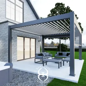4m x 3m aluminium pergola with adjustable louvered roof, attached to a stone house, featuring outdoor lounge furniture and garden backdrop.